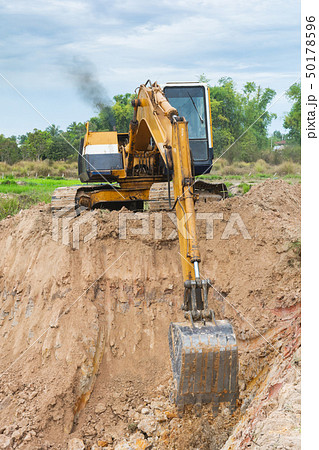 Yellow excavator machine working earth moving Yellow excavator machine working earth moving 50178596