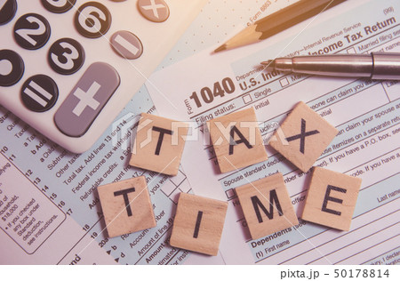 Tax time with wooden alphabet blocks, calculator, 50178814