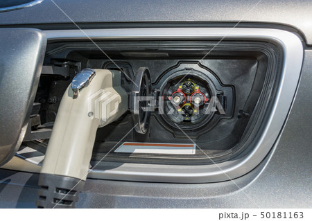 Electric plug connected to a vehicle for battery recharging from the station Electric plug connected to a vehicle for battery recharging from the station 50181163