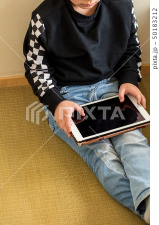小学生の男の子がタブレットを持って遊んでいる学習している勉強現代時代 50183212