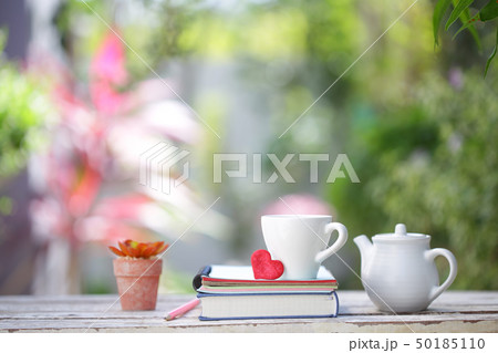 White kettle and cup with red heart and notebooks 50185110