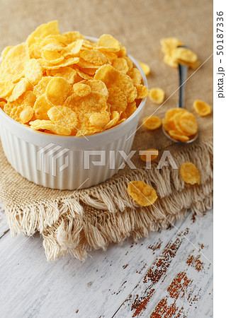 Bowl with golden flakes on a linen, on a light Bowl with golden flakes on a linen, on a light 50187336