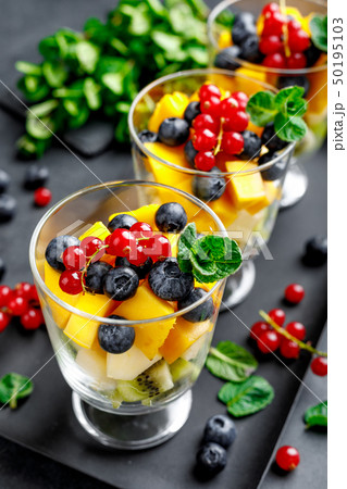Fresh salad with fruits and berries in glass. 50195103