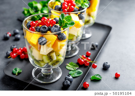 Fresh salad with fruits and berries in glass. Fresh salad with fruits and berries in glass. 50195104