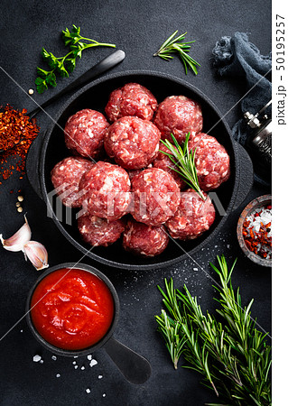 Fresh raw beef meatballs with spices and tomato Fresh raw beef meatballs with spices and tomato 50195257