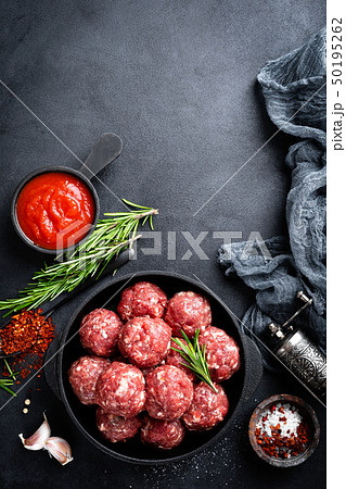 Fresh raw beef meatballs with spices and tomato 50195262