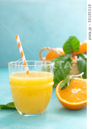 Orange freshly squeezed juice in glass and fresh 50195319