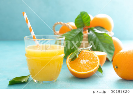 Orange freshly squeezed juice in glass and fresh 50195320