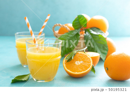 Orange freshly squeezed juice in glass and fresh 50195321