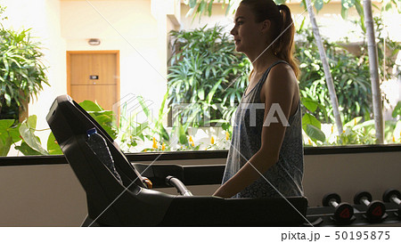 Attractive caucasian girl running on the treadmill in the sport gym 50195875