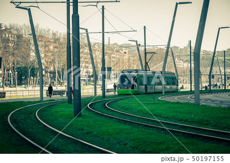 Tram rails covered with green grass 50197155