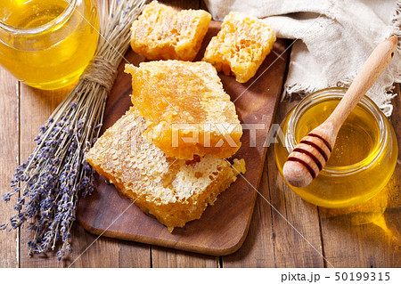 jar of lavender honey with honeycombs on wooden 50199315