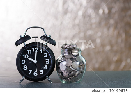 Alarm clock and step of coins stacks with coin in 50199633
