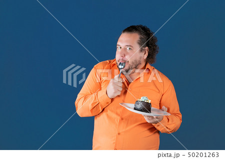 Funny fat man in orange shirt 50201263