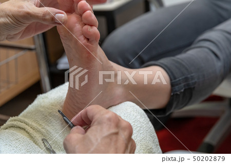 woman on pedicure and foot massage. Body care and relaxation for a healthy lifestyle. Spa procedures woman on pedicure and foot massage. Body care and relaxation for a healthy lifestyle. Spa procedures 50202879