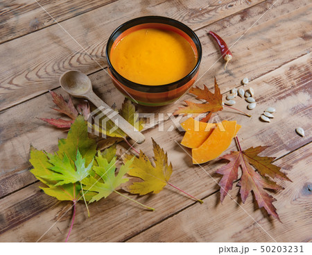 pumpkin soup bowl on rustic wooden background 50203231