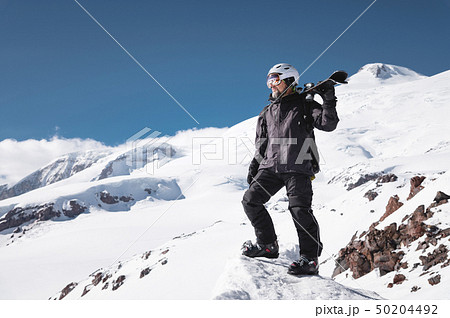 Growth Portrait bearded male skier aged against background of snow-capped Caucasus mountains. An 50204492