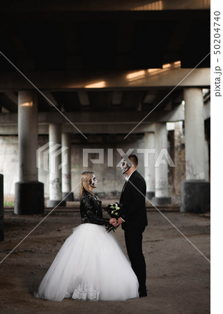 Halloween couple. Dressed in wedding clothes Halloween couple. Dressed in wedding clothes 50204740