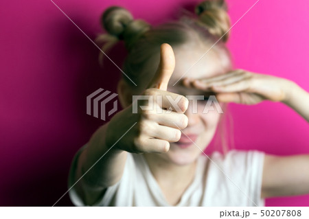 little girl blonde on a pink background 50207808