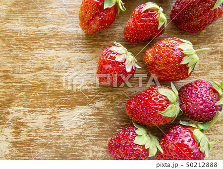 Strawberry on a wooden background. Strawberry on a wooden background. 50212888