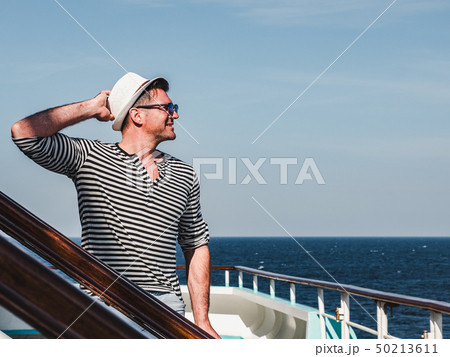 Smiling man on the empty deck of a liner Smiling man on the empty deck of a liner 50213611