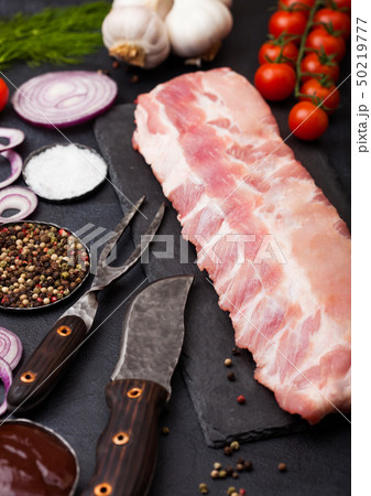 Fresh raw pork ribs on chopping board and vintage 50219777