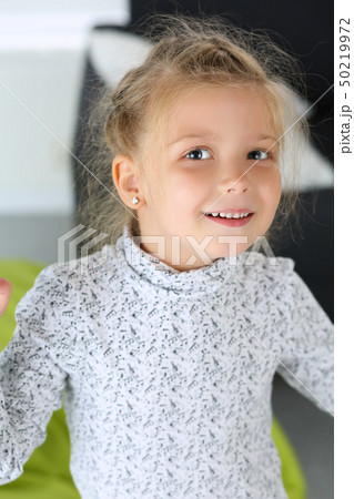 Amazed little blonde girl looking in camera portrait 50219972