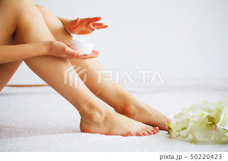 Long Woman Legs With Beautiful Smooth Skin. Closeup Of Female Hand