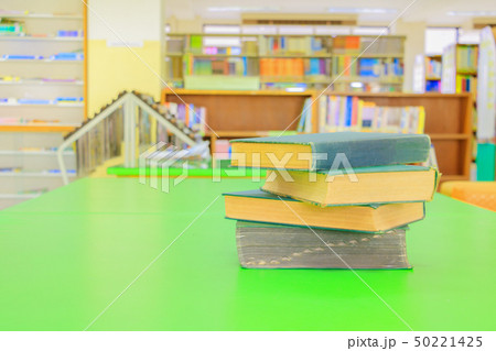 old book and heap treatise on table green 50221425