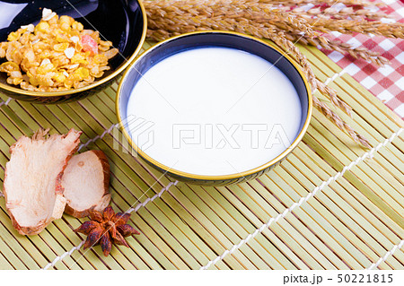 Milk in bowl with Cornflakes spices on wooden Milk in bowl with Cornflakes spices on wooden 50221815
