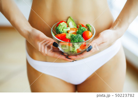 Health. Slim Girl Holding In Hands Fresh Salad. Young Girl in Wh Health. Slim Girl Holding In Hands Fresh Salad. Young Girl in Wh 50223782