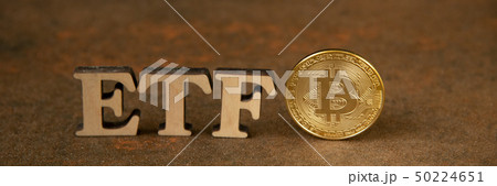 Bitcoin coin with ETF text on stone background 50224651