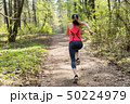 Fitness woman run in spring sunny forest 50224979