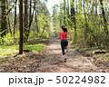 Female runner run in spring sunny forest 50224982