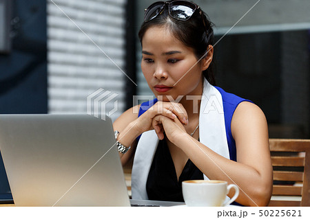 Beautiful vietnam female student using laptop pc outdoor Beautiful vietnam female student using laptop pc outdoor 50225621