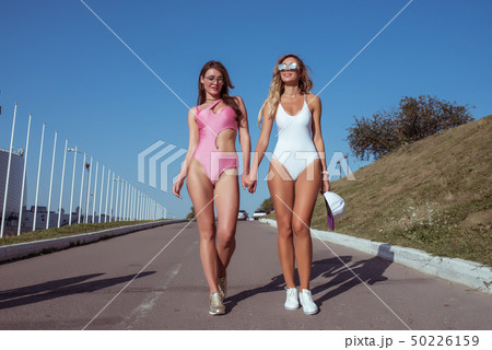 Girls girlfriends walk city swimsuits, summer city, friendly walk. Resting in nature, sunbathing 50226159