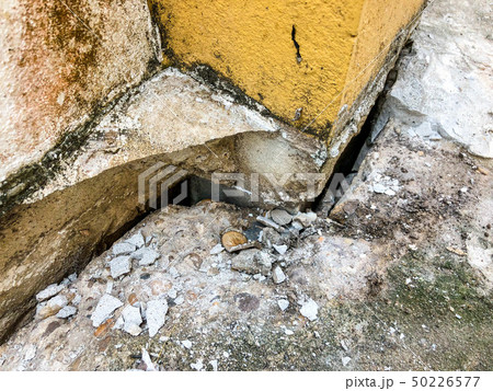 The cement floor collapsed and saw the crevices 50226577