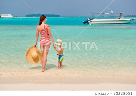 Toddler boy on beach with mother 50228051