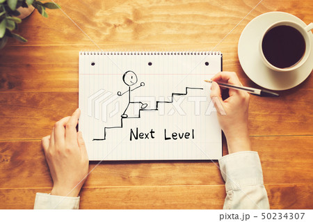Next level concept with a person holding a pen 50234307