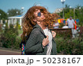 Wind waving red haired girl in sunglasses 50238167