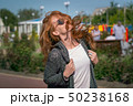 Wind waving red haired girl in sunglasses 50238168
