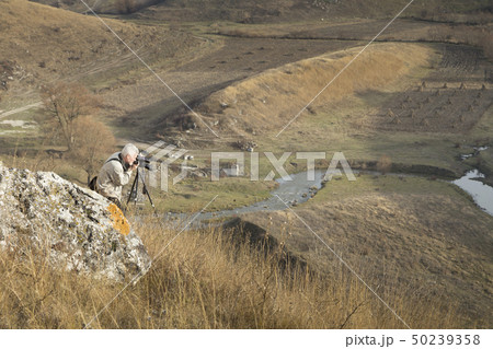 The photographer is doing a landscape shooting. 50239358