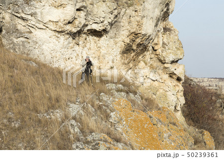 The photographer is doing a landscape shooting. 50239361