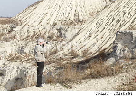 The photographer is doing a landscape shooting. 50239362