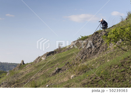 The photographer is doing a landscape shooting. 50239363