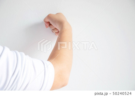 woman use her fist pounding the wall. woman use her fist pounding the wall. 50240524