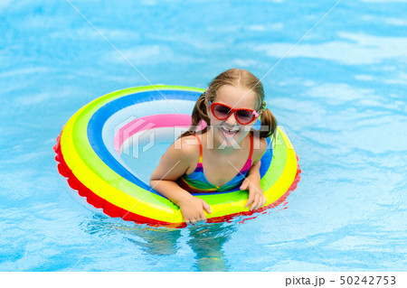 Child in swimming pool on toy ring. Kids swim. Child in swimming pool on toy ring. Kids swim. 50242753