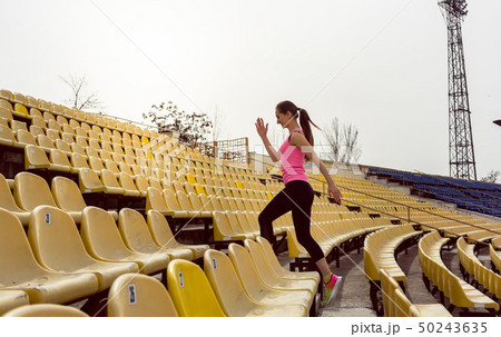 Woman walking on staircase Woman walking on staircase 50243635