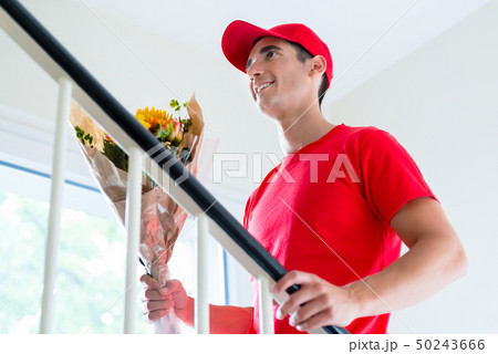 Delivery man holding flower bouquet gift 50243666