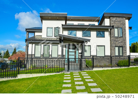 New residential house with concrete tile pathway and metal fence New residential house with concrete tile pathway and metal fence 50248971